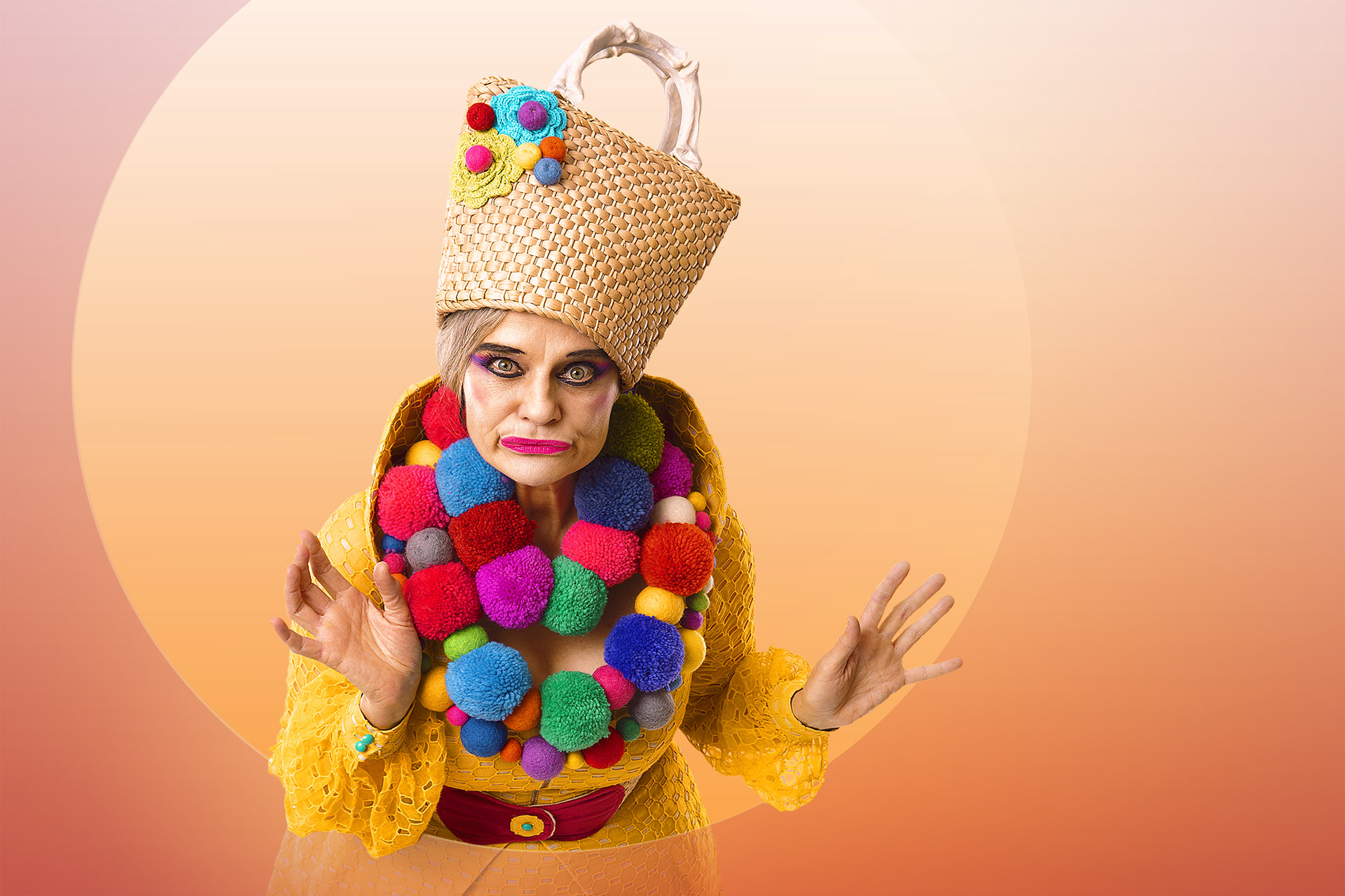 Image of woman with a basket for a hat and a bright coloured pompom necklace